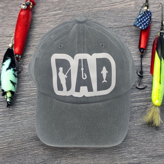 Gray trucker dad hat with breathable cotton, perfect for fishing enthusiasts and outdoor adventurers. Casual lifestyle shot showcasing HTV fishing-themed design, lightweight and comfortable for everyday wear.