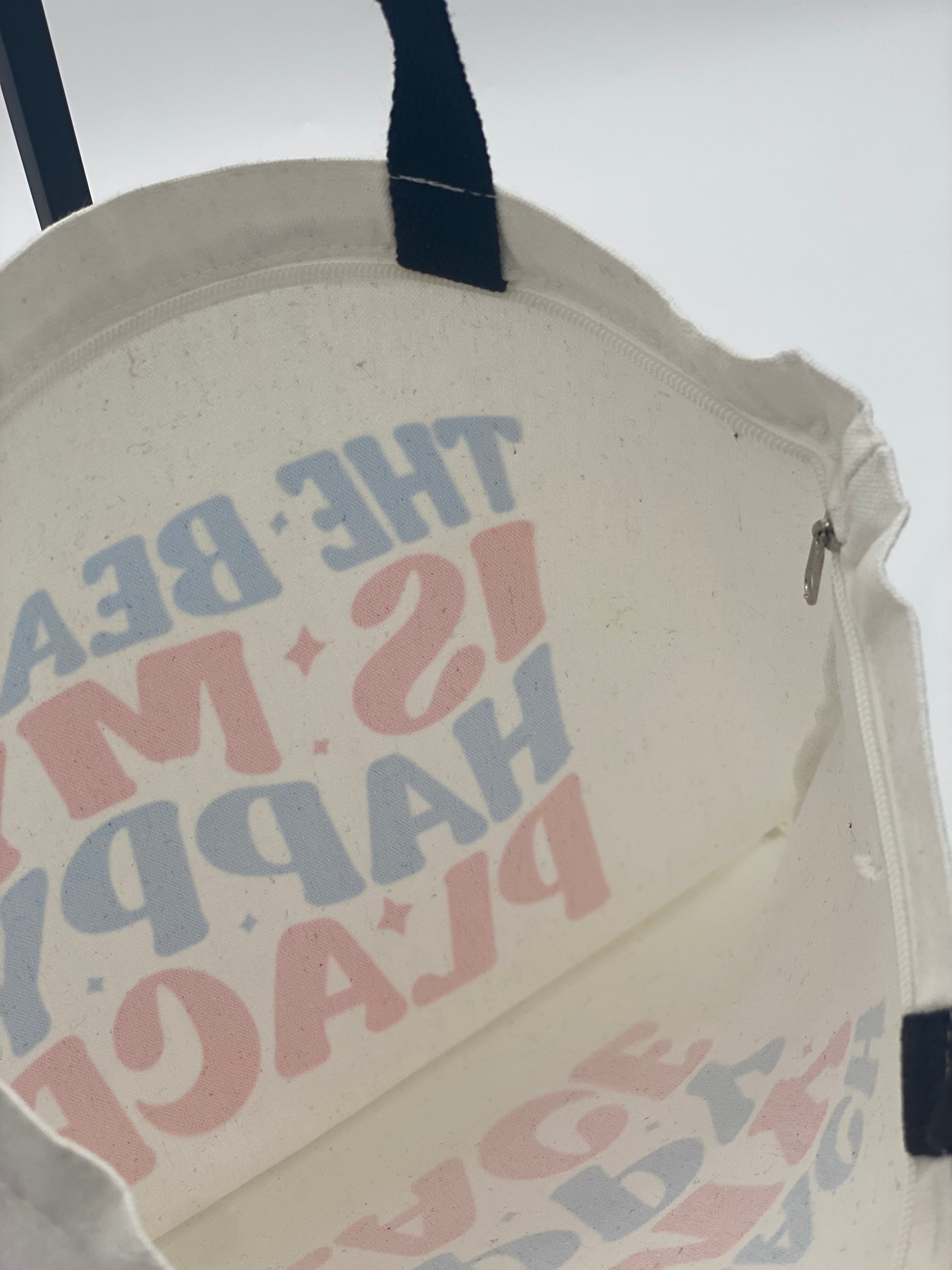Inside of  tote bag with text and graphic design on a plain background.