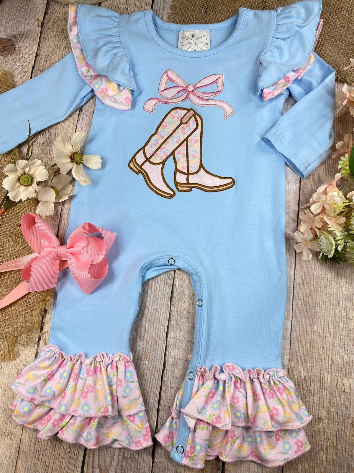 Seaside Custom Apparel & Gifts blue infant romper with cowgirl boot embroidery, flutter sleeves, and floral ruffles.