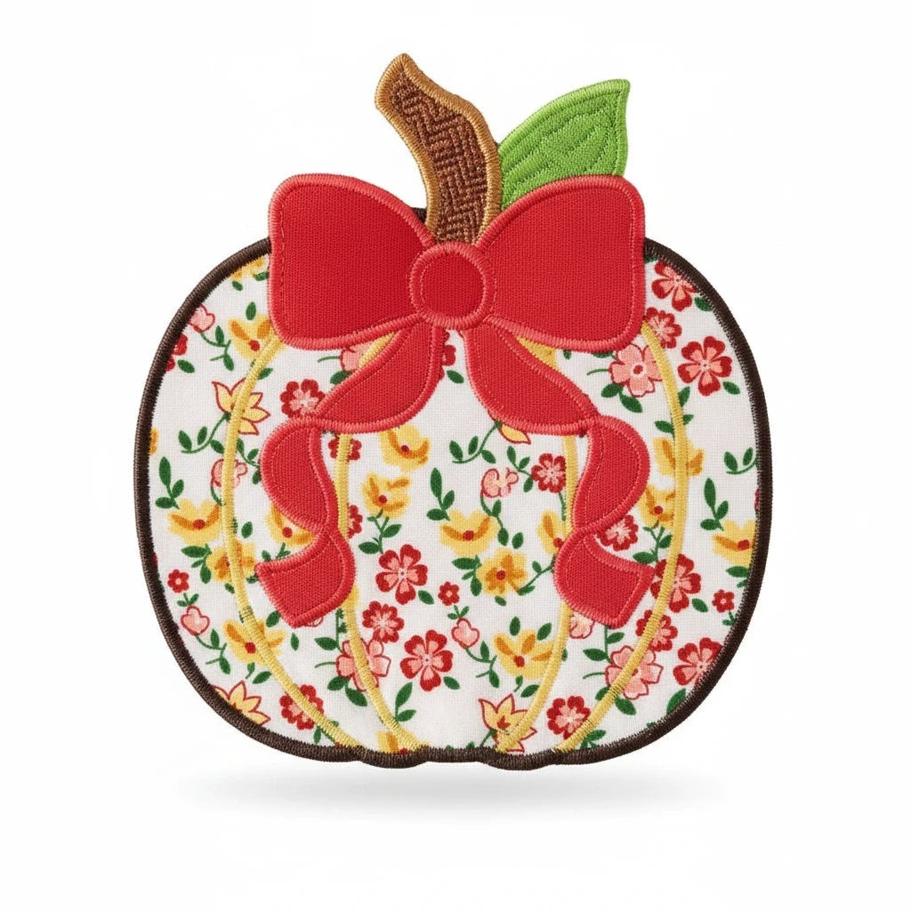 Seaside Custom Apparel & Gifts floral pumpkin applique with a red bow, green leaf, and brown stem on white fabric