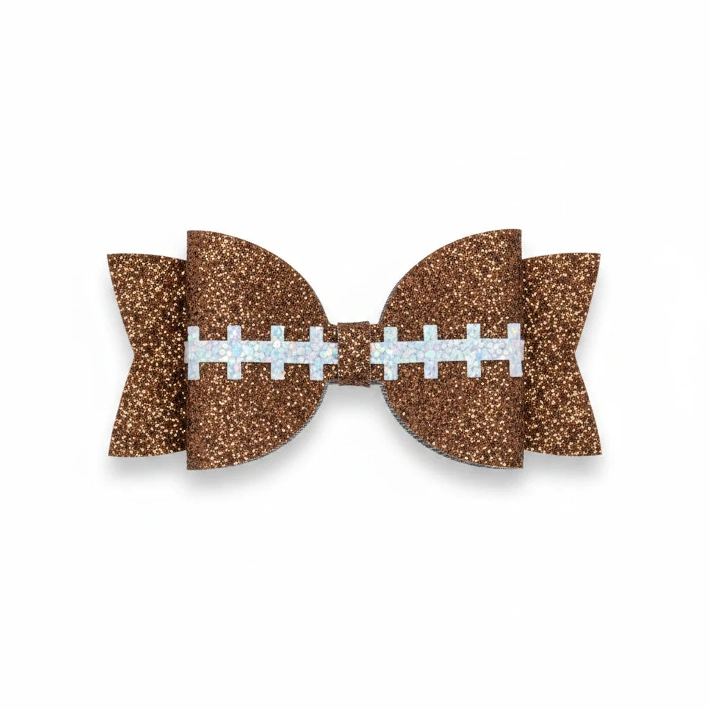 Seaside Custom Apparel & Gifts brown glitter football hair bow with white stitching detail on an alligator clip