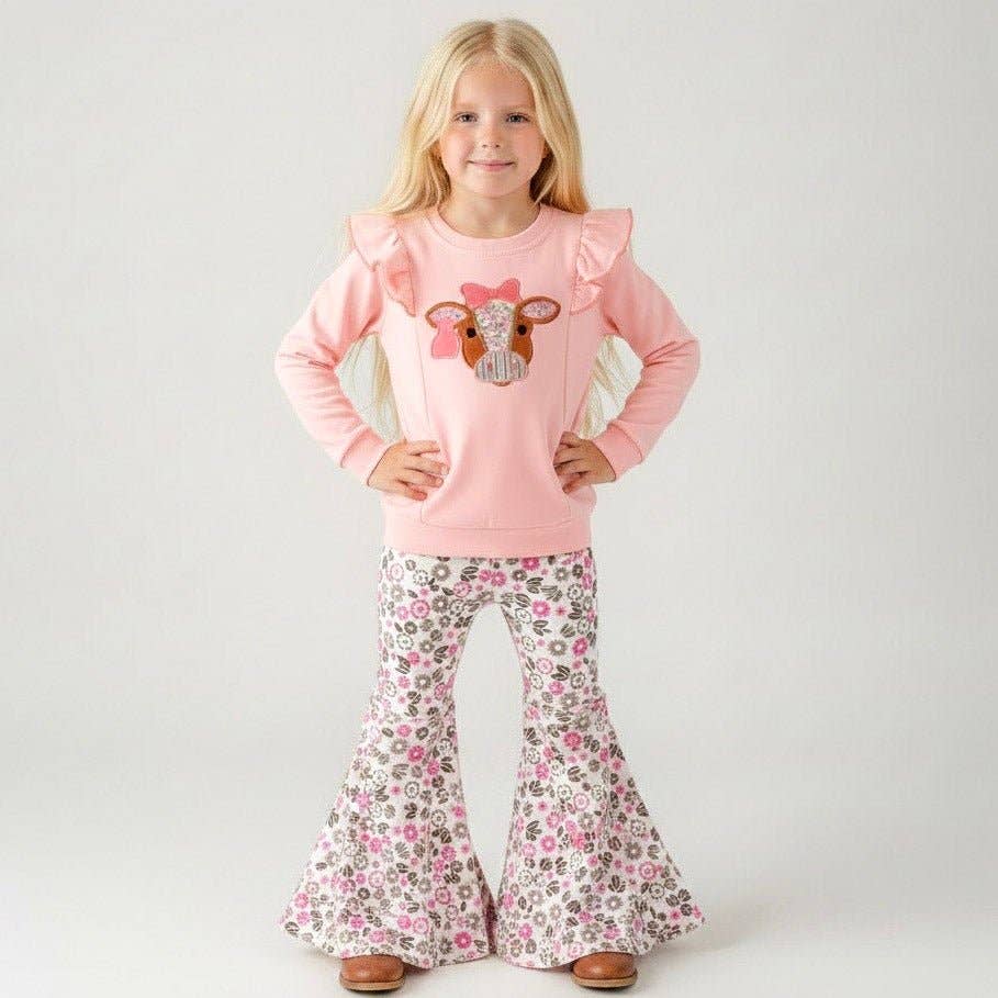 Seaside Custom Apparel & Gifts pink long sleeve top with cow applique and floral bell bottom pants on a young girl