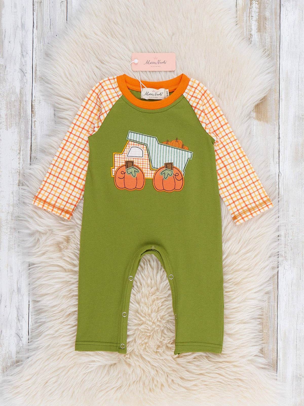 Seaside Custom Apparel & Gifts pumpkin dump truck embroidered romper with orange plaid sleeves on a faux fur rug