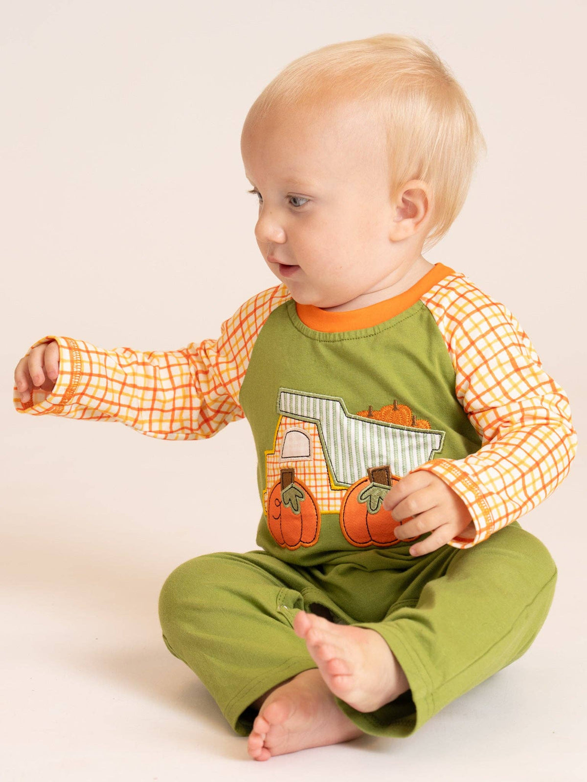 Seaside Custom Apparel & Gifts baby wearing a green and orange plaid pumpkin dump truck embroidered fall romper