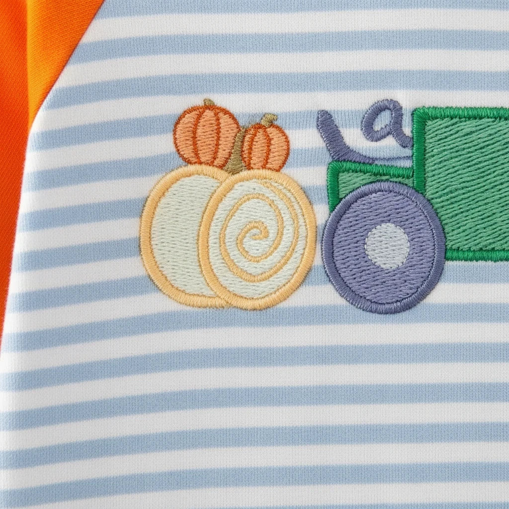 Seaside Custom Apparel & Gifts infant romper featuring blue and white stripes, orange sleeves, and tractor embroidery.