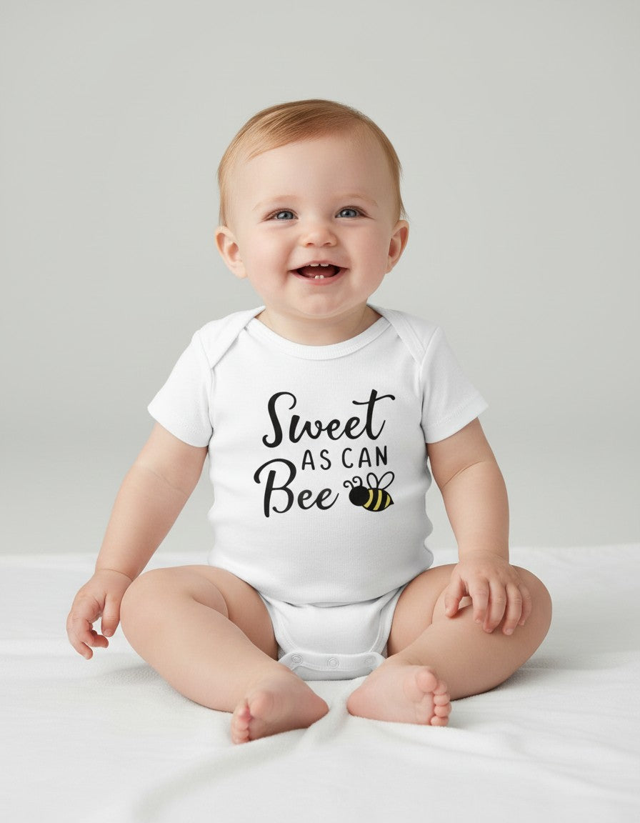 Seaside Custom Apparel & Gifts white cotton baby onesie with Sweet as can BEE print worn by a smiling baby