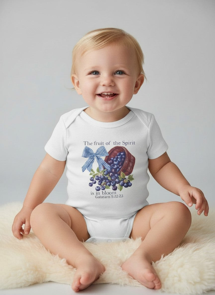 Seaside Custom Apparel & Gifts white baby onesie with Fruit of the Spirit blueberry basket print on a soft rug