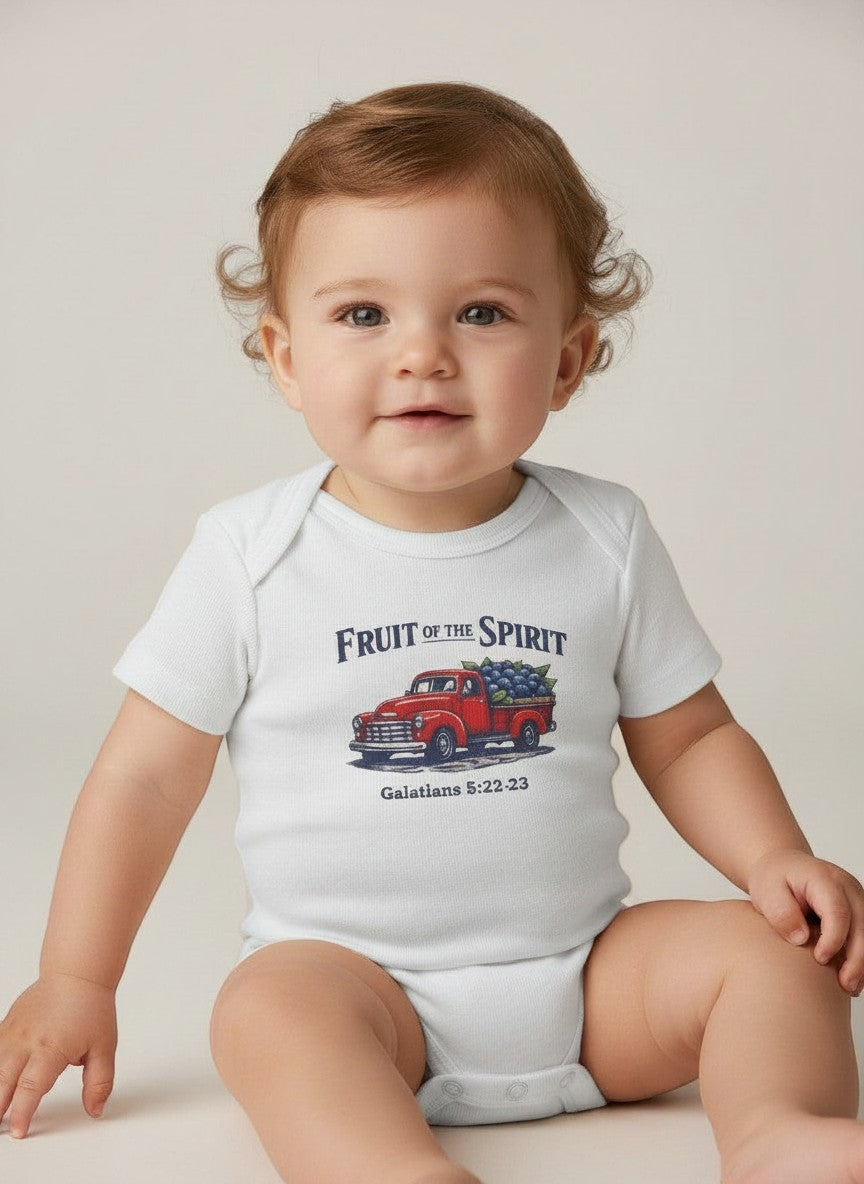 Baby wearing a white Seaside Custom Apparel & Gifts onesie with a Fruit of the Spirit red truck graphic print.