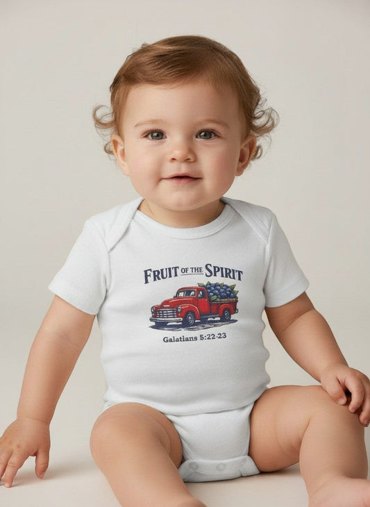 Baby wearing a white Seaside Custom Apparel & Gifts onesie with a Fruit of the Spirit red truck graphic print.