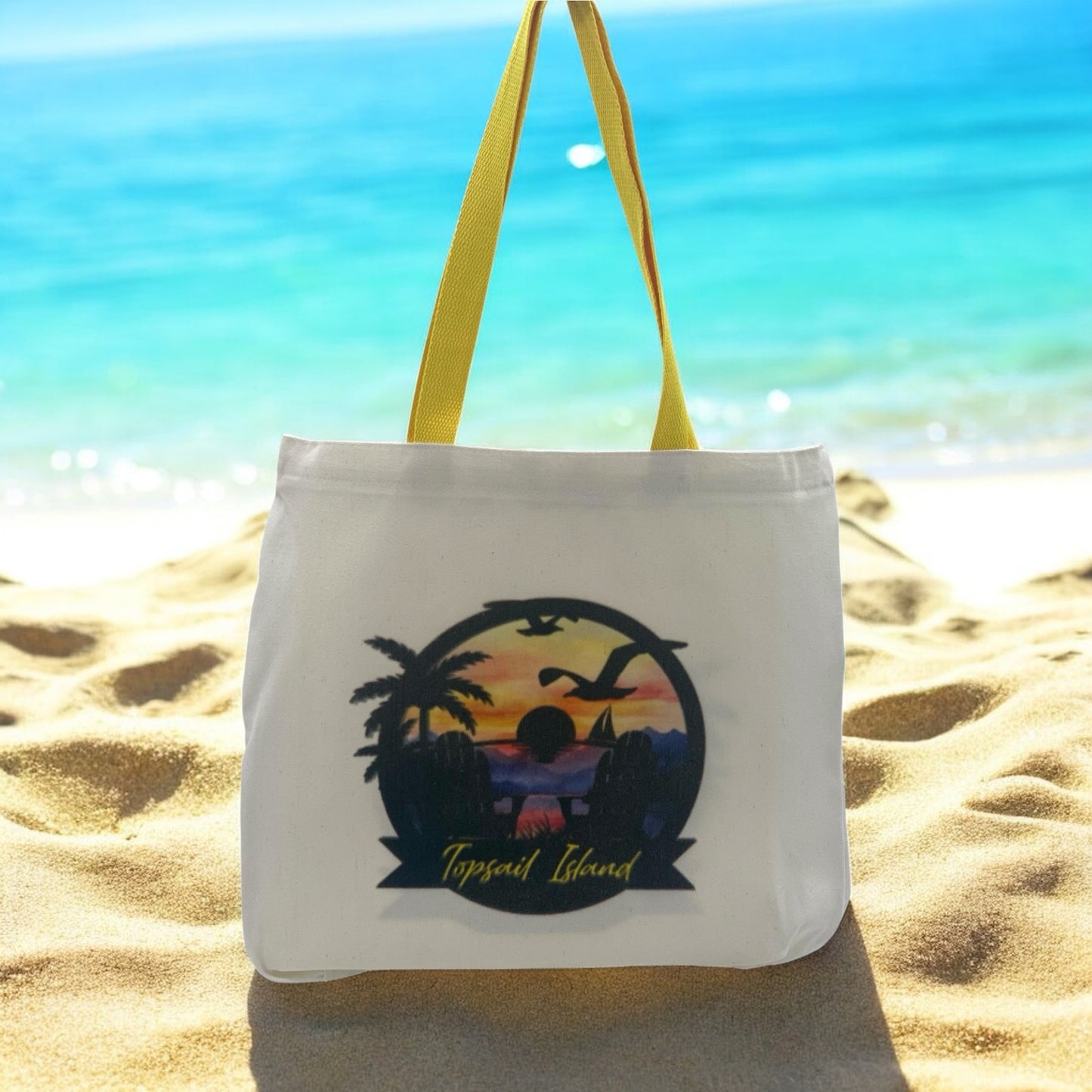 White tote bag with yellow handles and Topsail Beach design with sunset in background.